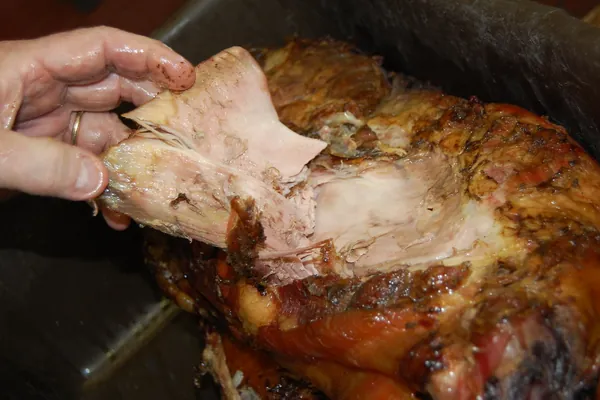 A slow-cooked pork shoulder being pulled apart